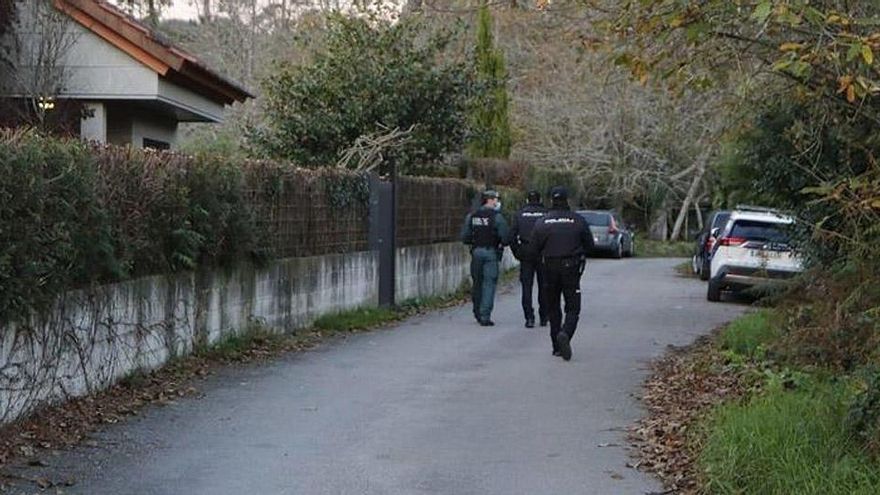 Policías y guardias civiles junto a la vivienda en la que se produjo el crimen.