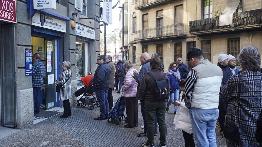 Persones fent cua ahir el matí davant l’administració de loteria Merche de Girona. | MARC MART