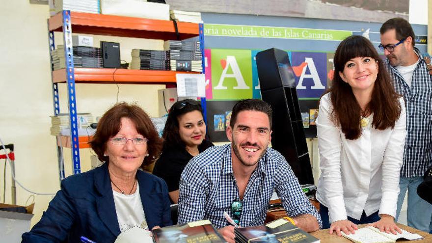 En la imagen, Nieves, esposa de Adolfo Santana, y sus dos hijos, Juan y Gara, ayer firmando ejemplares.