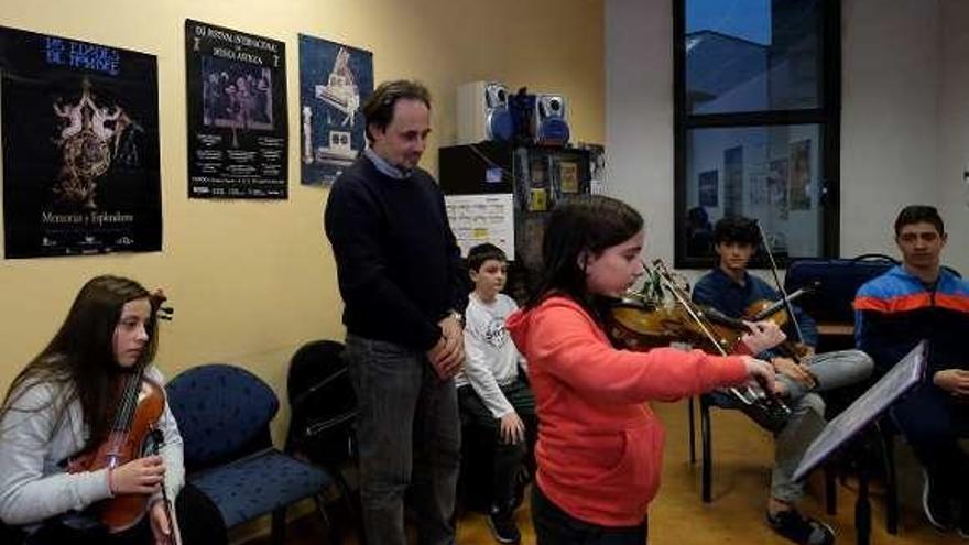 Mauro Rossi supervisa a una alumna de violín.