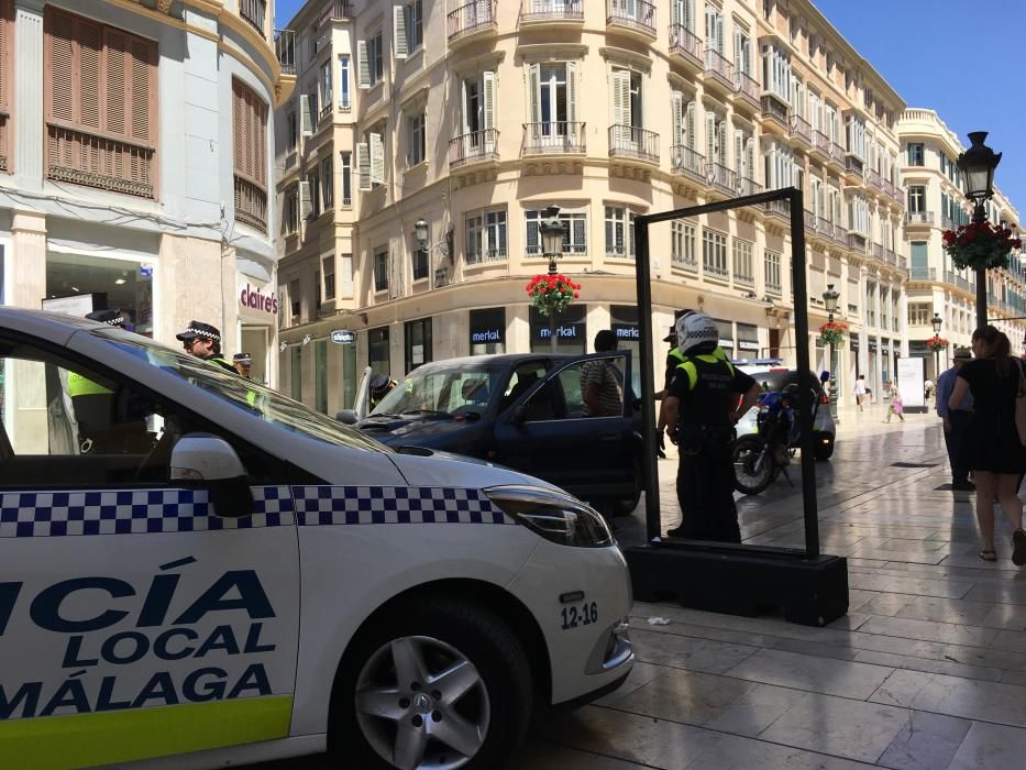 Detención de un hombre con su coche en la calle Larios.