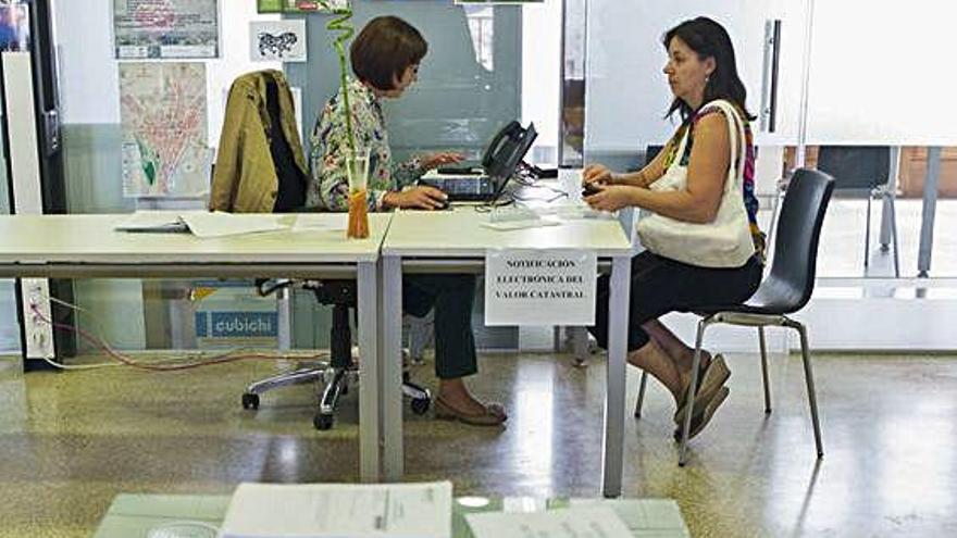 Una empleada municipal atiende a una contribuyente en la sede de la Plaza Mayor.