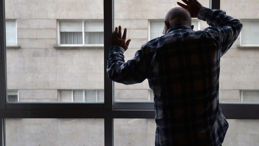 Una persona mayor  mira por la ventana desde  su domicilio. |   // GUSTAVO SANTOS