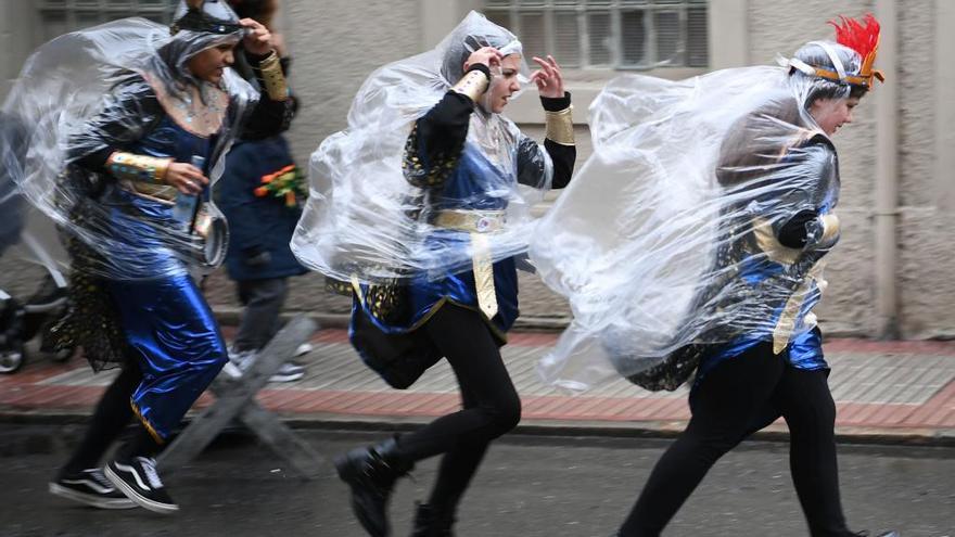 Disfrazados y con chubasquero en A Coruña.