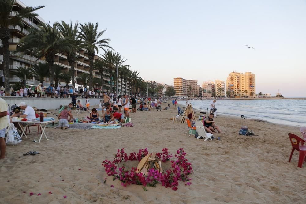 Noche de hogueras, baños, en las playas de la Vega Baja. En las imágenes grupos de amigos y familias en la playa del Cura de Torrevieja