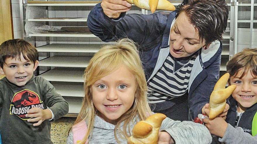 Unos niños muestran unos bollos en el “Día de Pedir”.  | // IÑAKI ABELLA