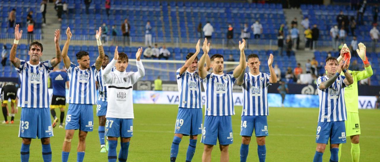 Los jugadores del Málaga CF celebran junto a la afición blanquiazul al término de un partido de la presente Liga en La Rosaleda.