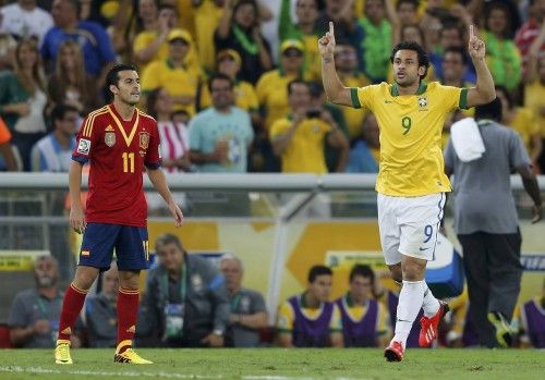 Brazil's Fred celebrates next to Spain's Pedro after scoring a goal against Spain during the Confederations Cup final soccer match in Rio de Janeiro