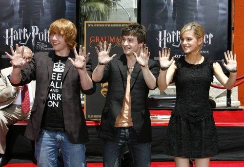 Cast members Daniel Radcliffe, Rupert Grint and Emma Watson from the movie "Harry Potter and the Order of the Phoenix" show their hands after leaving prints in cement in Hollywood