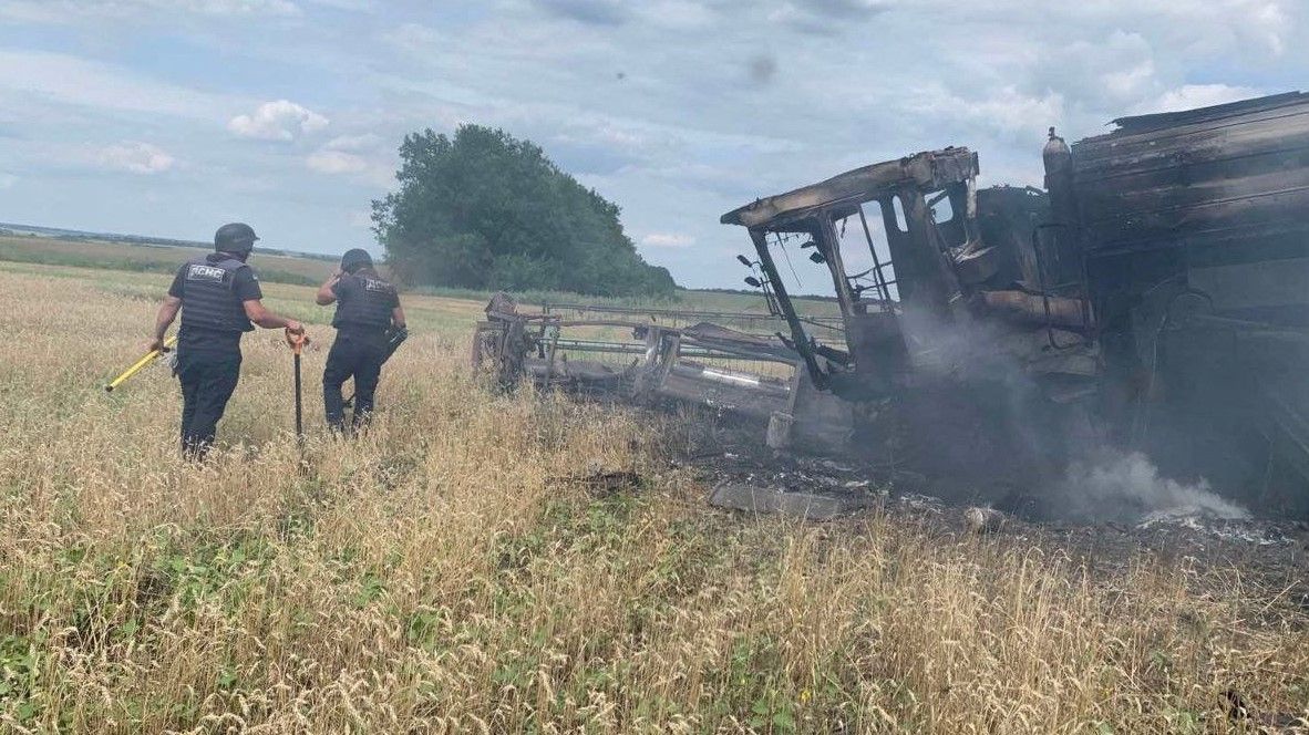 Russia's attack on Ukraine continues, in Kharkiv region Sappers of the State Emergency Service of Ukraine work near a burning harvesting combine, which exploded on anti-tank mine in a wheat field, as Russia's attack on Ukraine continues, near the village of Vilkhivka, in Kharkiv Region, Ukraine July 30, 2022. Press service of the State Emergency Service of Ukraine/Handout via REUTERS ATTENTION EDITORS - THIS IMAGE HAS BEEN SUPPLIED BY A THIRD PARTY. MANDATORY CREDIT