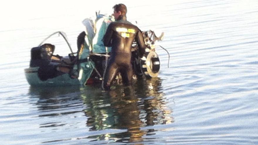 Un agente de la Guardia Civil sujeta la cabina del helicóptero.