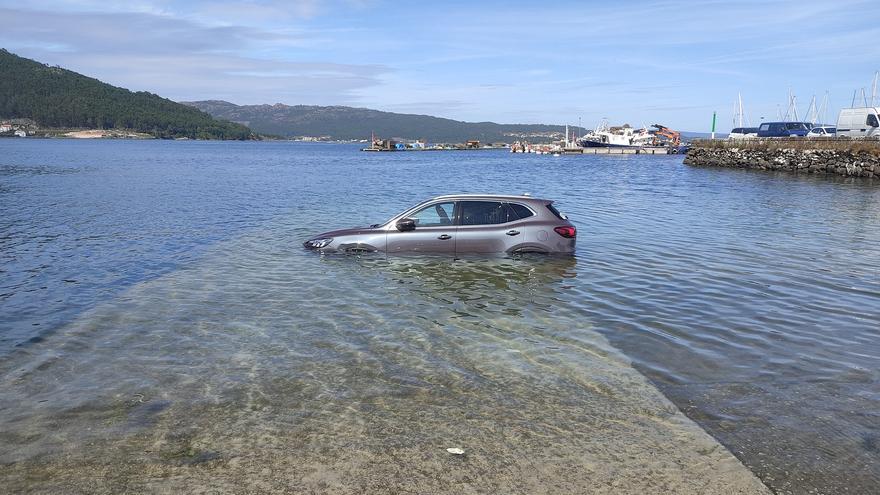 La marea inunda un coche que se encontraba aparcado en el puerto de Muros: &quot;Sempre pasa cos turistas&quot;