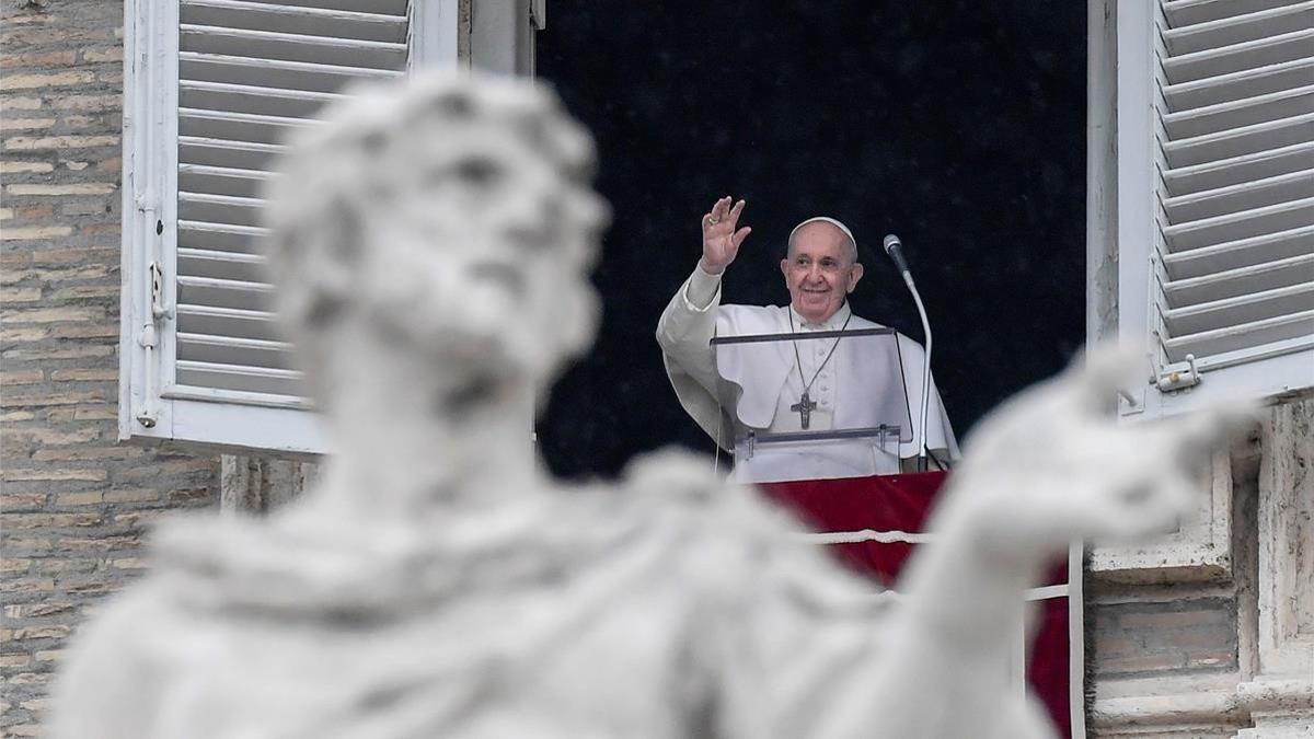 Pope Francis waves from the window of the apostolic palace overlooking St  Peter s Square during the weekly Angelus prayer on February 7  2021 in the Vatican  during the Covid-19 pandemic  (Photo by Filippo MONTEFORTE   AFP)