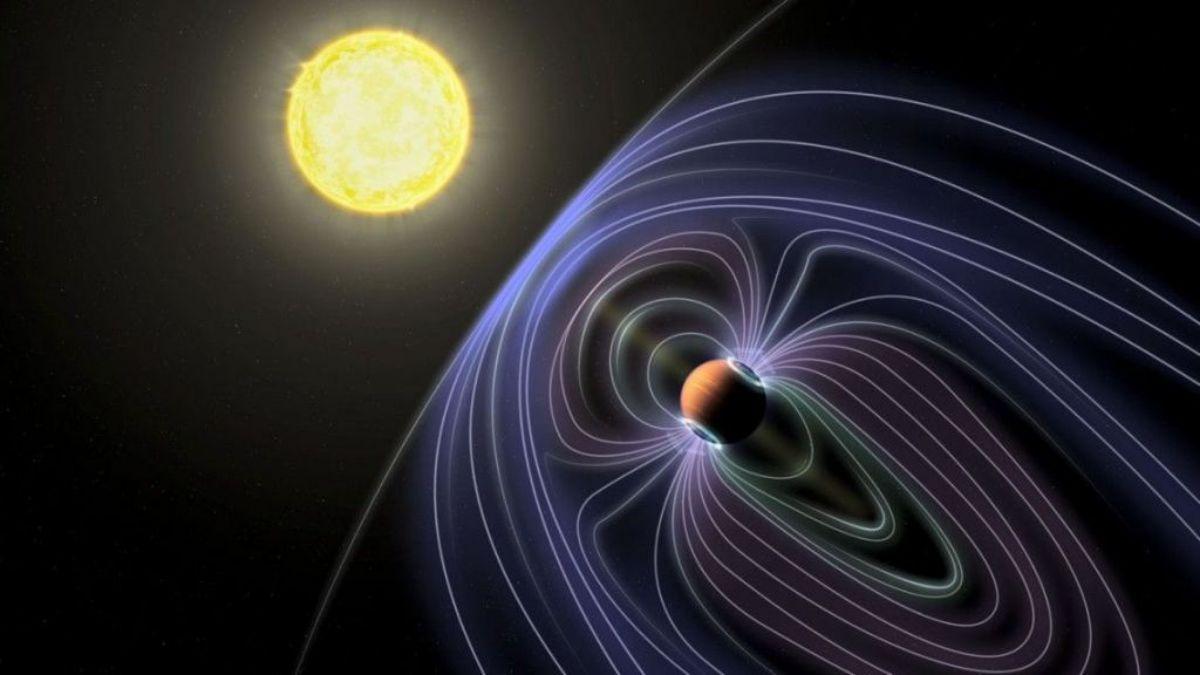 Representación artística del sistema Tau Bootes b, que muestra al exoplaneta y su campo magnético, ubicados a aproximadamente 50 años luz de la Tierra.