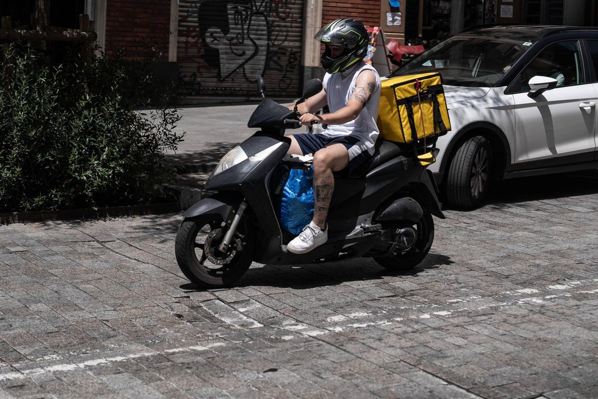 Una moto atraviesa el pavimento deteriorado de la calle Pi i Margall, en Barcelona.