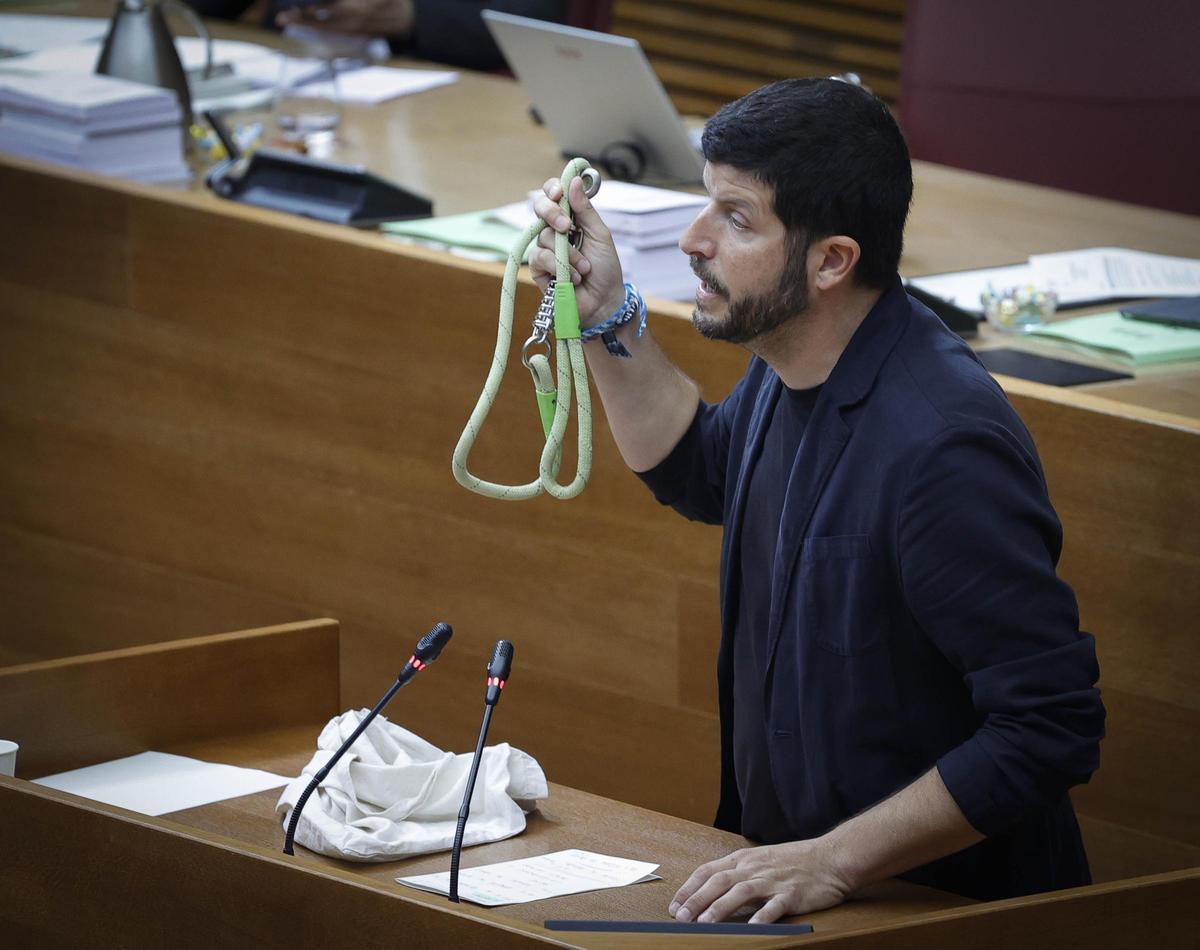 El diputado de Compromís, Carles Esteve, muestra una correa en la tribuna de las Corts, este miércoles.