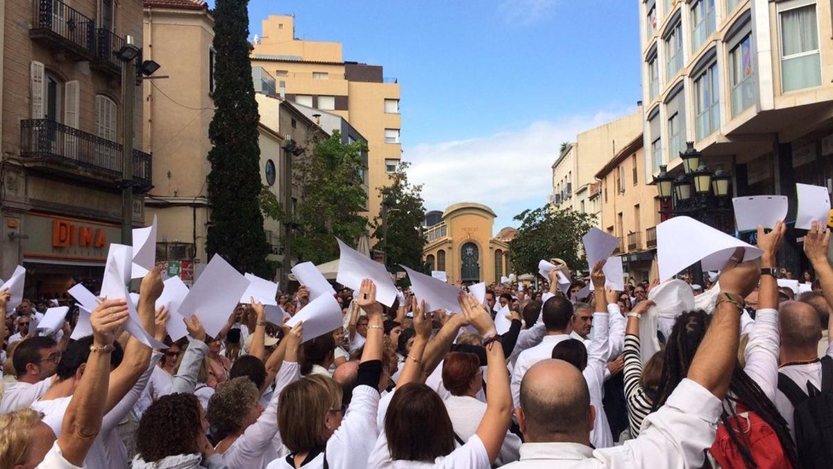 Los concentrados en la manifestación a favor del diálogo en Terrassa alzan sus brazos con papeles en blanco.