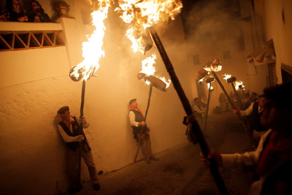 Villagers hold torches during the Divina Pastora ...