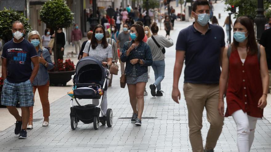 Gente paseando con mascarilla en Avilés