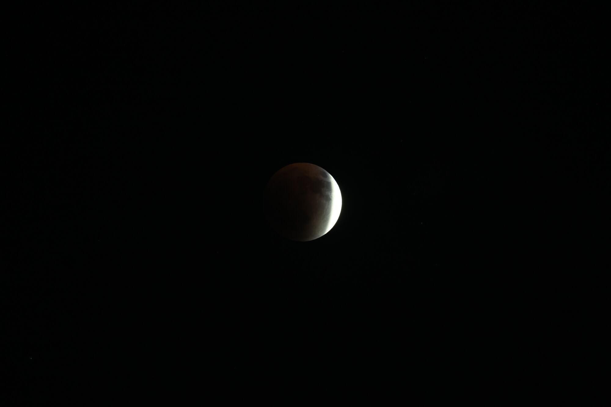 NABLUS (-), 07/09/2025.- The 'Blood Moon' is seen during a total lunar eclipse event visible from the suburbs of Nablus in the West Bank, 07 September 2025. Lunar eclipses, the opposite of solar eclipses, happen when the Earth is positioned between the full moon and sun. The red glow that is created earns these types of eclipses the title of 'blood moon.' EFE/EPA/ALAA BADARNEH