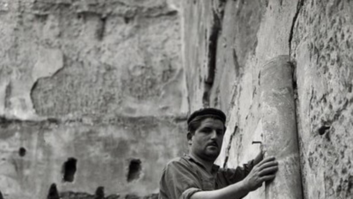 Un vecino de Sijena ayudando a Joaquim Pradell, restaurador del MNAC, a arrancar las pintura del monasterio, en 1960.