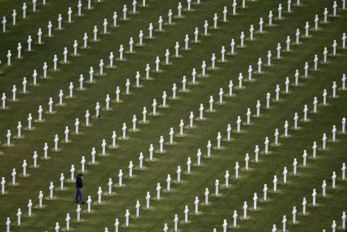 An aerial view shows a man walking among tombstones as he visits the World War II Normandy American Cemetery and Memorial at Colleville sur Mer, situated above Omaha Beach