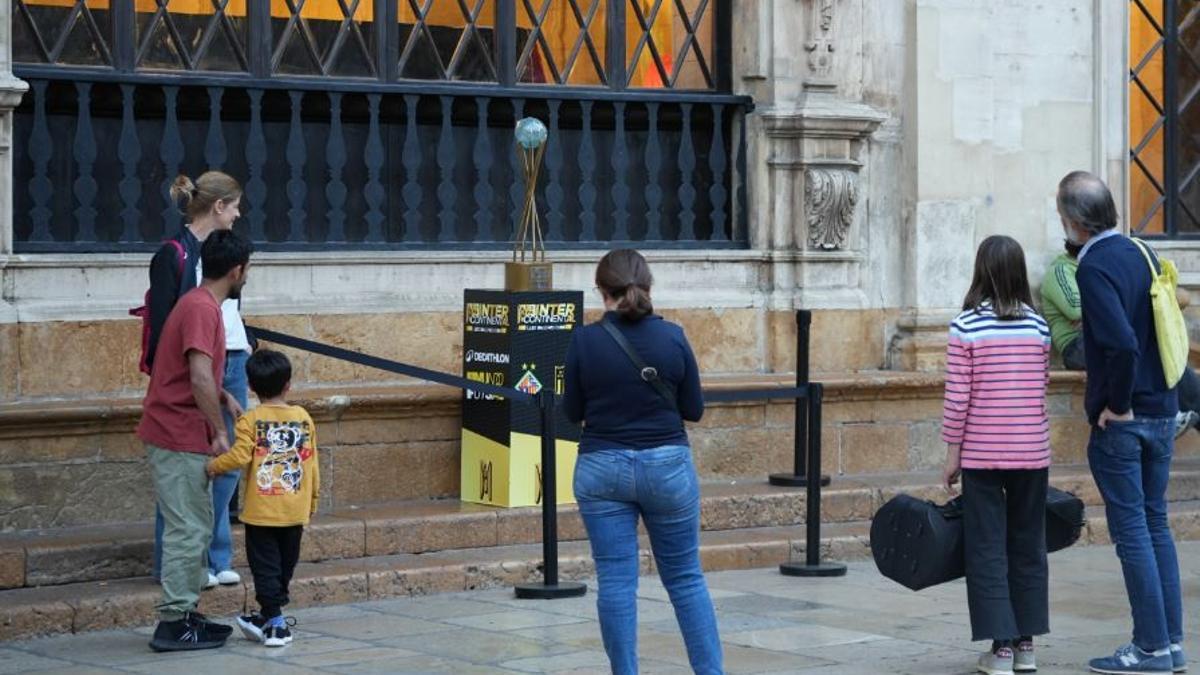 Unos curiosos observan la Copa Intercontinental instalado en Cort.