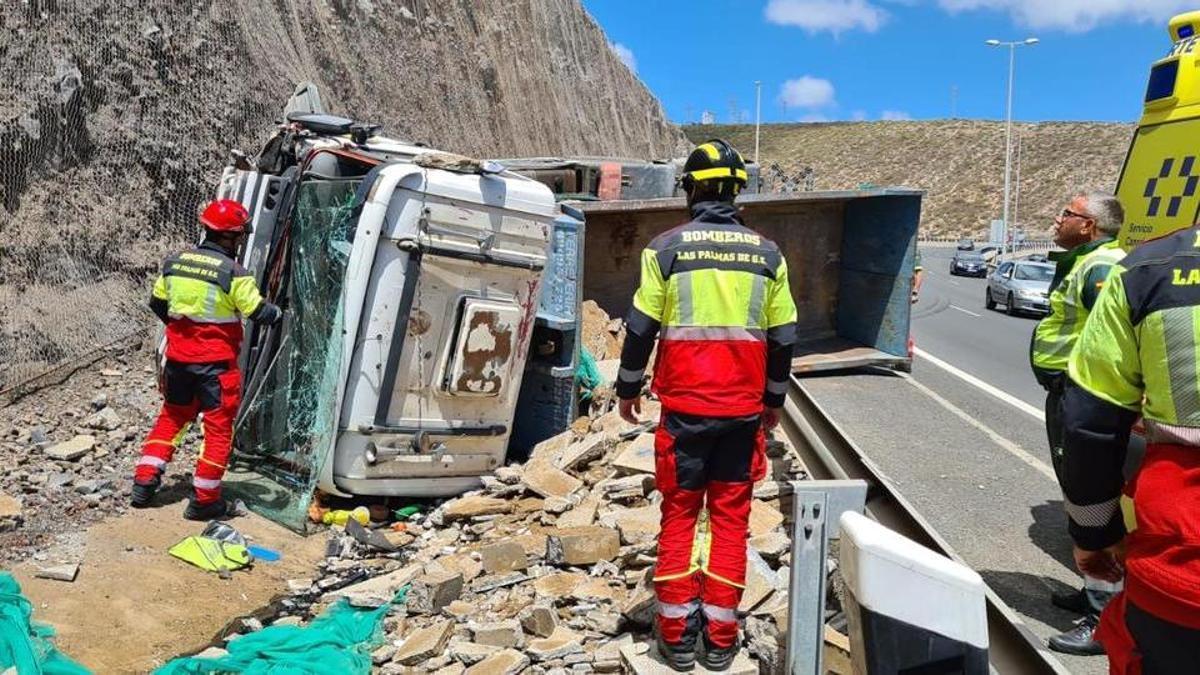 Los bomberos de Las Palmas de Gran Canaria junto al camión accidentado.