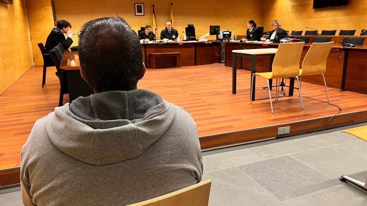 L'acusat, d'esquenes, durant el judici a l'Audiència de Girona.