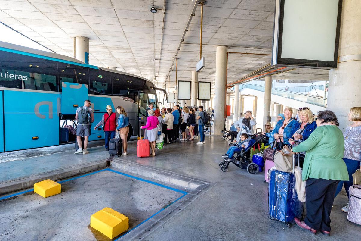 Viajeros nada más bajar de sus autobuses o esperando para embarcar, delante de carteleras inutilizadas o paneles que no funcionan.