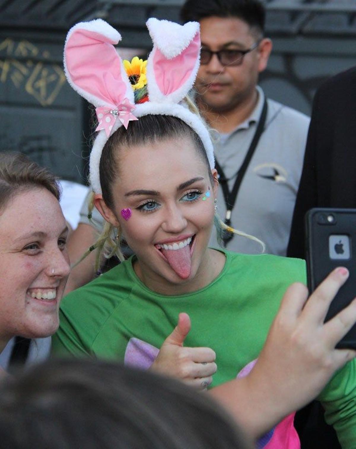 Miley Cyrus saca su famosa lengua para hacerse una foto con una fan