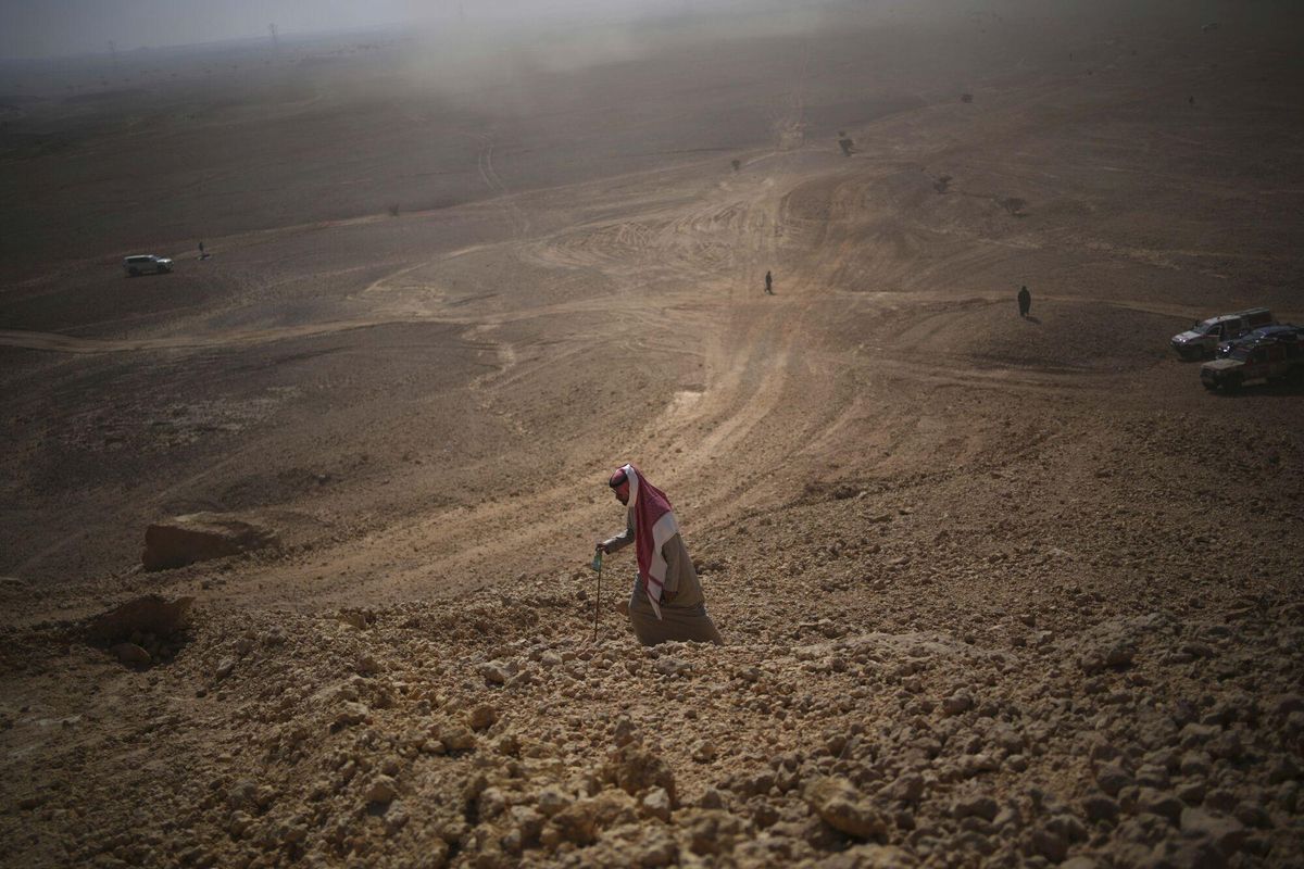 A man climbs to watch the drivers during the ninth stage of the Dakar Rally between Riyadh and Haradh, Saudi Arabia, Tuesday, Jan. 14, 2025. (AP Photo/Christophe Ena) Associated Press/LaPresse. EDITORIAL USE ONLY/ONLY ITALY AND SPAIN