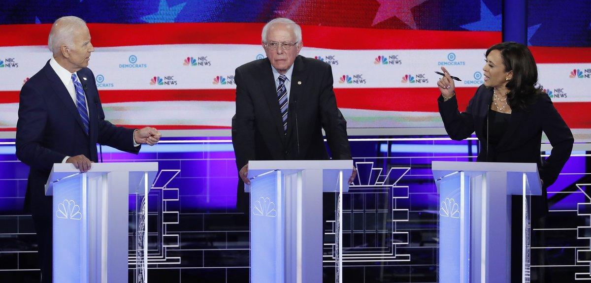 Former Vice President Joe Biden and Senator Kamala Harris debate racial issues as Senator Bernie Sanders listens during the second night of the first U S  Democratic presidential candidates 2020 election debate in Miami  Florida  U S   June 27  2019  REUTERS Mike Segar