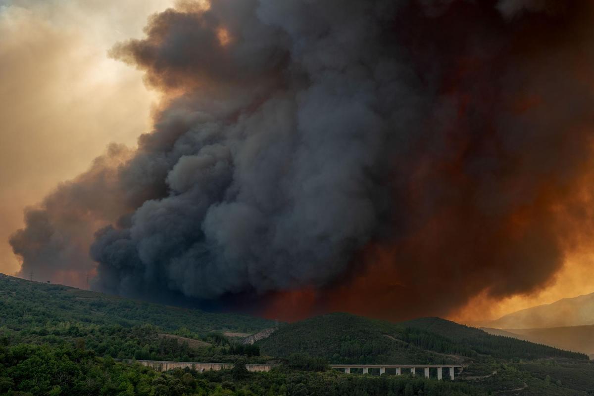 Dos vecinas de la localidad de A Veiga da Cascallá (Rubiá) lloran al observar los daños ocasionados en las viviendas por un incendio forestal este martes. EFE/ Brais Lorenzo