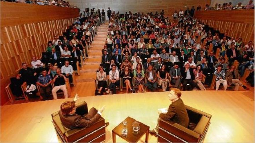 L&#039;alcalde, Carles Puigdemont, conversant amb l&#039;actor i director de teatre Martí Peraferrer, amb uns 400 assistents al públic.