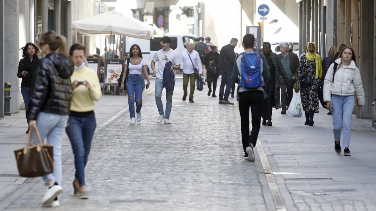 Vianants a l’extrem del carrer Nou més proper a la Gran Via de Jaume I. | ANIOL RESCLOSA