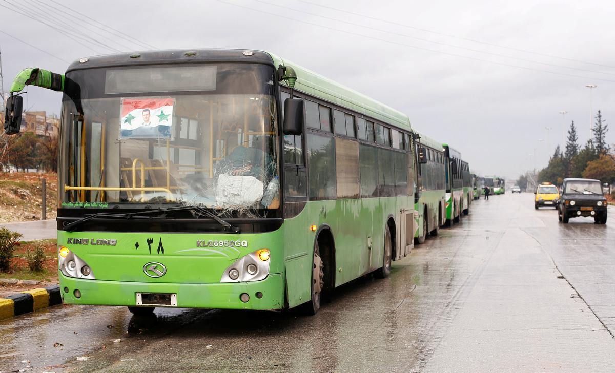 Buses wait to evacuate people from a rebel pocket in Aleppo, in the government-controlled al-Hamadaniah Stadium of Aleppo, Syria December 14, 2016. REUTERS/Omar Sanadiki
