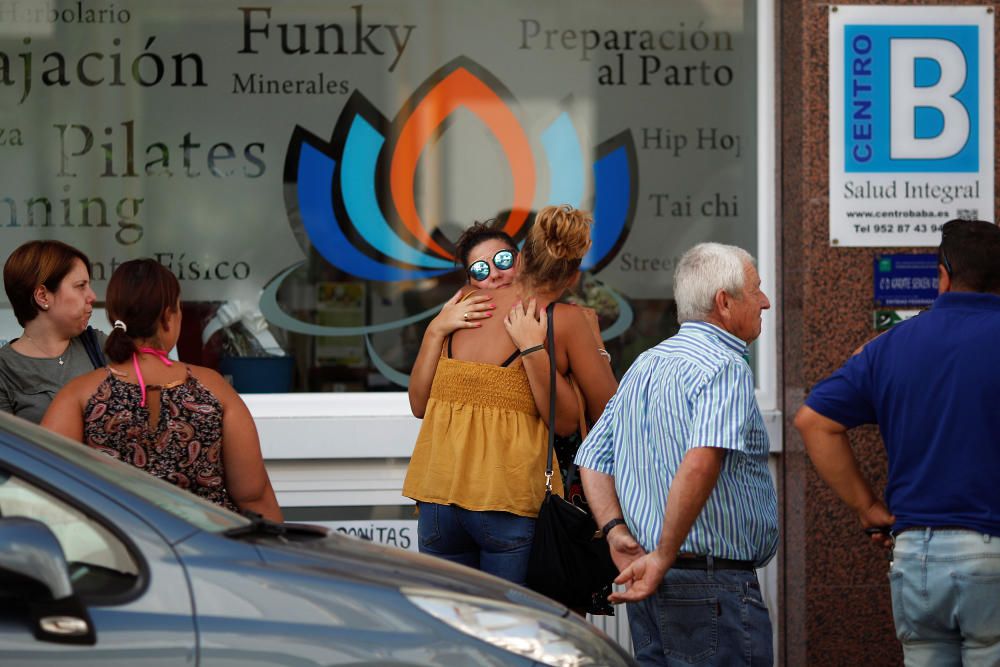 Friends and relatives of the victims embrace ...