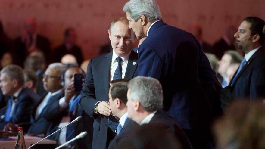 Putin y el secretario de Estado de EE UU, John Kerry, conversando en la cumbre del clima, en París.