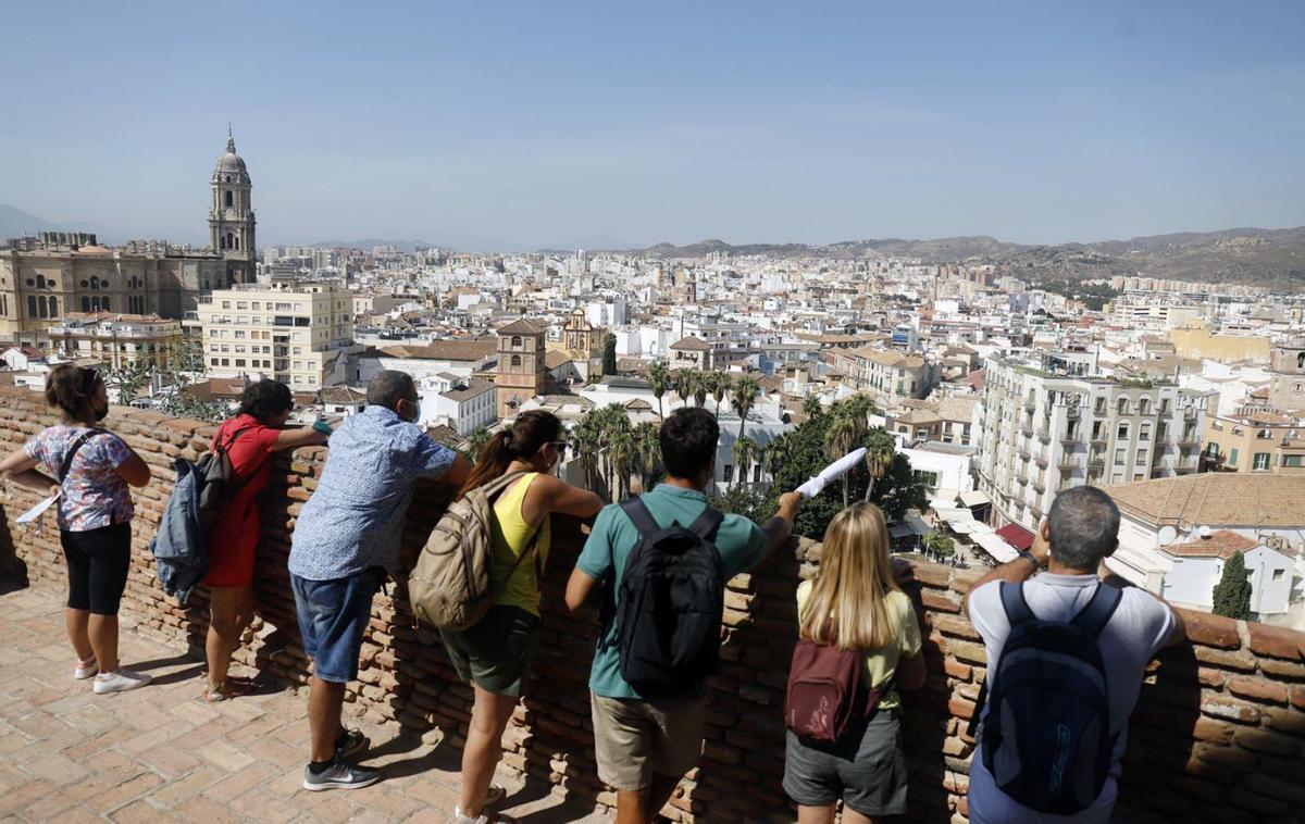 Turistas contemplan la ciudad desde la Alcazaba. | ÁLEX ZEA