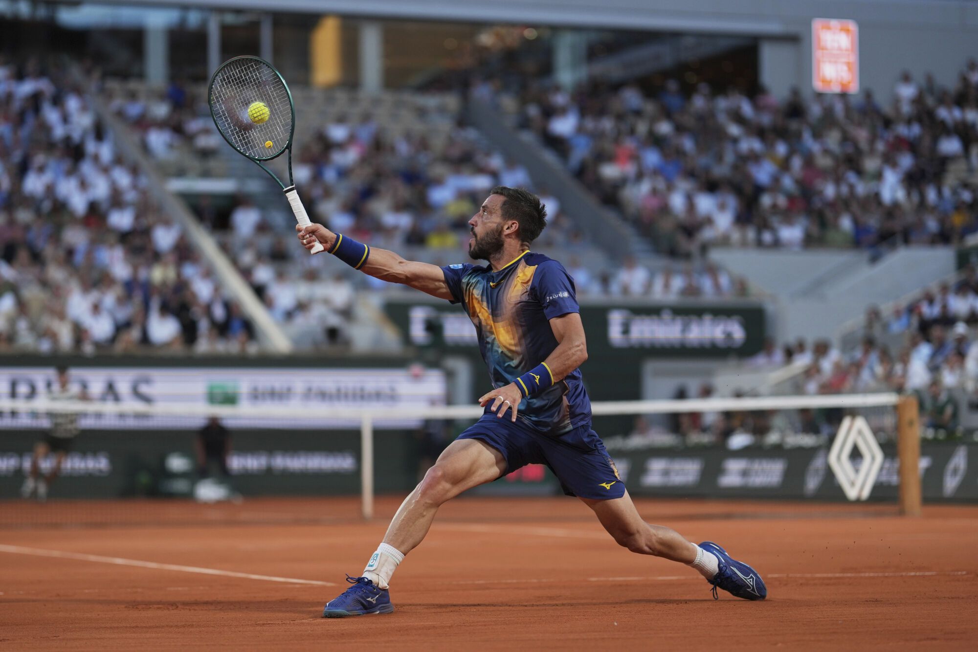 Bosnia and Herzegovina's Damir Dzumhur returns the ball to Spain's Carlos Alcaraz during their third round match at the French Open tennis tournament at the Roland-Garros stadium, Friday, May 30, 2025, in Paris. (AP Photo/Thibault Camus)