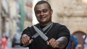 El cocinero posa con dos cuchillos en la calle Villavieja de Alicante.