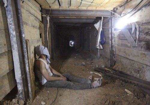 A tunnel worker rests inside a smuggling tunnel dug beneath the Gaza-Egypt border in the southern Gaza Strip