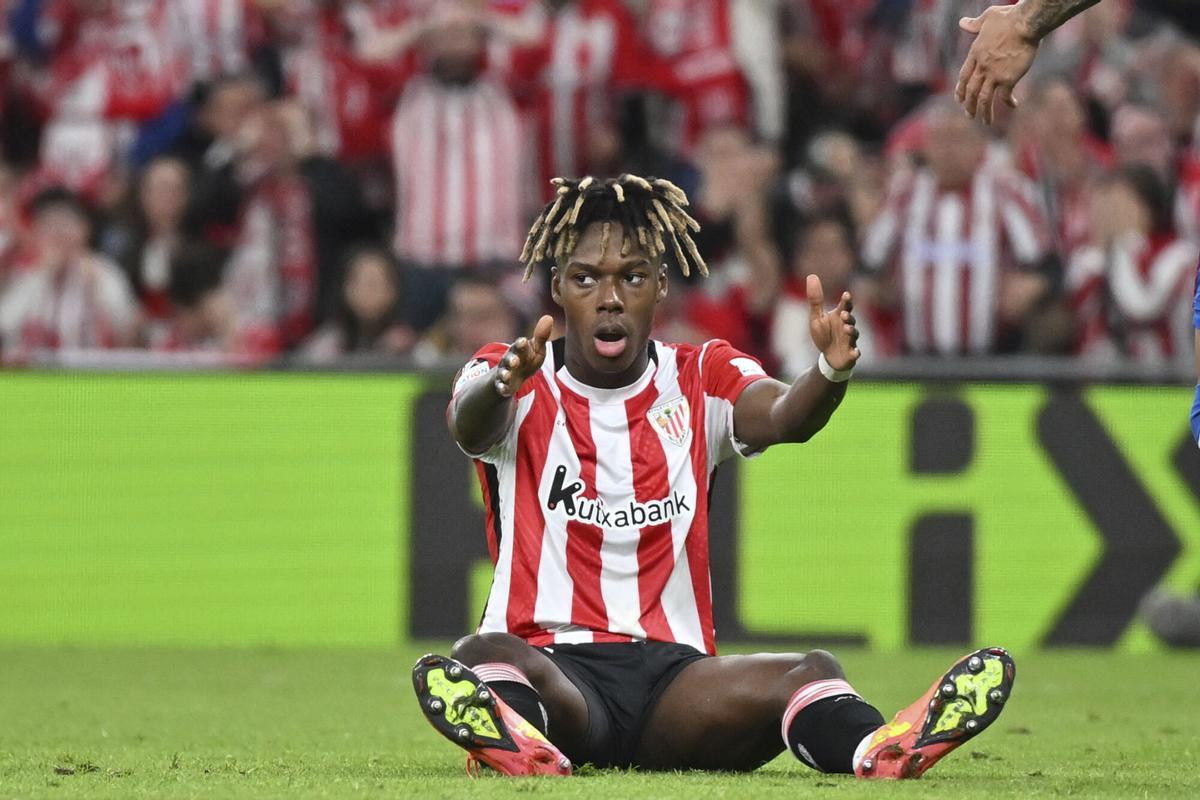 Athletic Bilbao's Nico Williams sits on the ground during the Europa League quarter final second leg soccer match between Athletic Bilbao and Glasgow Rangers in Bilbao, Spain, Thursday, April 17, 2025. (AP Photo/Miguel Oses)