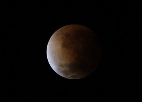 The moon is seen as it begins a total lunar eclipse over Buenos Aires
