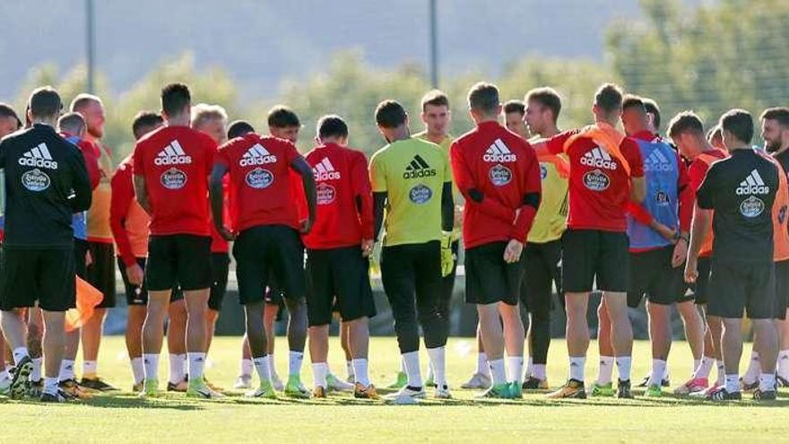 El cuerpo técnico charla con los jugadores al inicio del entrenamiento de ayer. // Marta G. Brea