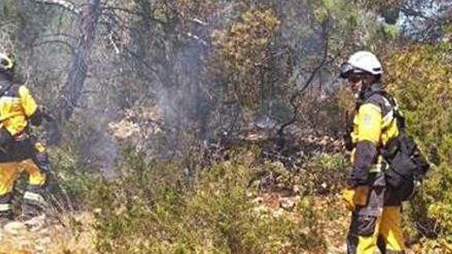 Dos agentes del Ibanat, anteayer en Cala Bassa durante las labores de extinción.