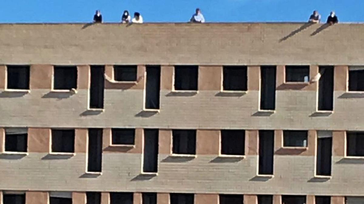 Media docena de aficionados en la azotea de la residencia durante un partido del Intercity.