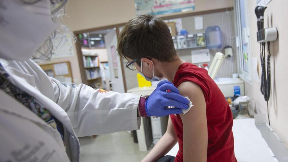 Una pediatra vacunando a un niño en un centro de salud