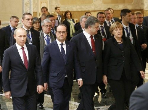 Russia's President Putin, Ukraine's President Poroshenko, Germany's Chancellor Merkel and France's President Hollande walk during peace talks in Minsk